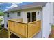 Backyard deck with wooden railing and vinyl siding on this home at 1645 Cobbs Creek Ln, Decatur, GA 30032