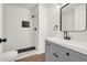 Bathroom with gray vanity, new fixtures, and walk-in shower with black accent tile at 1645 Cobbs Creek Ln, Decatur, GA 30032