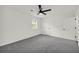 Bedroom with neutral carpet, ceiling fan, and an ensuite bathroom entrance at 1645 Cobbs Creek Ln, Decatur, GA 30032