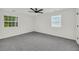 Bright bedroom features neutral carpet, ceiling fan, and double windows providing natural light at 1645 Cobbs Creek Ln, Decatur, GA 30032