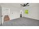 Light-filled bedroom with neutral carpet, ceiling fan, and an ensuite bathroom entrance at 1645 Cobbs Creek Ln, Decatur, GA 30032