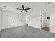 Bedroom with neutral carpet, ceiling fan, and ensuite bathroom with patterned tile at 1645 Cobbs Creek Ln, Decatur, GA 30032