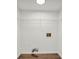 Empty closet space with upper shelving, utility hookups, and wood flooring at 1645 Cobbs Creek Ln, Decatur, GA 30032