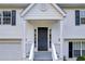 Welcoming front entrance of a two-story home with black door and white trim at 1645 Cobbs Creek Ln, Decatur, GA 30032