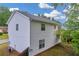 View of the back exterior featuring white siding, windows, and a small deck at 1645 Cobbs Creek Ln, Decatur, GA 30032