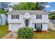 Charming two-story home with white siding, black shutters, and well-manicured lawn at 1645 Cobbs Creek Ln, Decatur, GA 30032