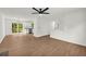 Open-concept living room and kitchen with wood floors and lots of natural light at 1645 Cobbs Creek Ln, Decatur, GA 30032