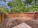 Backyard area enclosed by a wooden fence with a gate and mature trees at 1805 Ashborough Se Cir # H, Marietta, GA 30067
