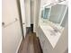 Bright bathroom featuring a single sink with a large mirror and wood-look floors at 1805 Ashborough Se Cir # H, Marietta, GA 30067