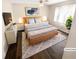 Staged bedroom with a queen bed, modern décor, a ceiling fan, and natural light at 1805 Ashborough Se Cir # H, Marietta, GA 30067