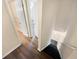 Hallway with wood-look flooring, white trim, and access to the basement stairs at 1805 Ashborough Se Cir # H, Marietta, GA 30067
