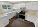 Bright kitchen featuring ample white cabinets, stainless steel appliances and a window overlooking the backyard at 1805 Ashborough Se Cir # H, Marietta, GA 30067