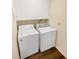 Practical laundry room with stacked washer and dryer, and built-in cabinets at 1805 Ashborough Se Cir # H, Marietta, GA 30067
