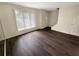 Bright living room featuring hardwood floors, large windows, and a neutral color palette at 1805 Ashborough Se Cir # H, Marietta, GA 30067