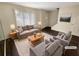 Staged living room featuring a neutral color scheme, large window and cozy furnishings at 1805 Ashborough Se Cir # H, Marietta, GA 30067