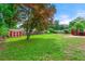 Expansive backyard showcases a lush green lawn, a handy storage shed, and a charming outdoor deck at 273 Hardwood Ln, Lawrenceville, GA 30044
