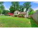 Exterior home showcasing its charming appeal with a spacious yard and mature trees at 273 Hardwood Ln, Lawrenceville, GA 30044