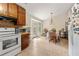 Bright kitchen features white appliances and wooden cabinets with a connecting dining area at 273 Hardwood Ln, Lawrenceville, GA 30044