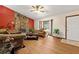 Inviting living room boasts a stone fireplace, hardwood flooring, and large windows at 273 Hardwood Ln, Lawrenceville, GA 30044
