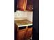 A cabinet with damaged floors and grime on the counter at 401 Camelot Dr, Atlanta, GA 30349