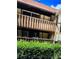 A condo with upper and lower balconies and brown wood railings, and green hedges at 401 Camelot Dr, Atlanta, GA 30349
