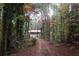 Scenic view of home nestled in a wooded lot featuring mature trees and a long driveway at 618 Old Doss Dr, Canton, GA 30115