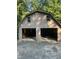 Detached garage with ample space for parking and storage in a wooded area at 618 Old Doss Dr, Canton, GA 30115