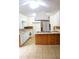 Kitchen features white cabinets, wood paneled breakfast bar, and updated appliances at 618 Old Doss Dr, Canton, GA 30115