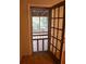 Back door with a screen door showing the outdoor patio with wooded background at 618 Old Doss Dr, Canton, GA 30115