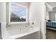 Soaking tub next to window with natural light, and next to bedroom door at 741 Jackson Ct, Social Circle, GA 30025