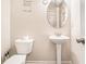 Cozy half-bathroom with a pedestal sink, a toilet, and decorative wall art creating a functional and inviting space at 741 Jackson Ct, Social Circle, GA 30025