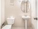 Simple and clean half bathroom with a modern pedestal sink and toilet at 741 Jackson Ct, Social Circle, GA 30025