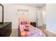 Bright bedroom featuring a twin bed and dark wood dresser at 741 Jackson Ct, Social Circle, GA 30025
