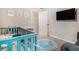 Bedroom featuring blue crib, changing table, and mounted television at 741 Jackson Ct, Social Circle, GA 30025