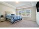 Spacious bedroom with a tray ceiling, carpet, and ample natural light from the large windows at 741 Jackson Ct, Social Circle, GA 30025