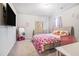 Cozy bedroom with a television, carpet, and playful decor at 741 Jackson Ct, Social Circle, GA 30025
