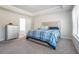 Bedroom featuring a tray ceiling, carpet, and a bright, welcoming atmosphere at 741 Jackson Ct, Social Circle, GA 30025