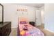 Cozy bedroom featuring a twin bed, dresser, and playful decor at 741 Jackson Ct, Social Circle, GA 30025