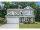 Charming two-story home featuring a two-car garage and a welcoming front porch in a well-manicured yard at 741 Jackson Ct, Social Circle, GA 30025