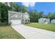 A charming two-story home with a long driveway and ample green space, perfect for outdoor activities and relaxation at 741 Jackson Ct, Social Circle, GA 30025
