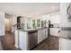 Modern kitchen with an island featuring granite countertops and stainless steel appliances, perfect for culinary enthusiasts at 741 Jackson Ct, Social Circle, GA 30025