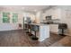 Modern kitchen with an island featuring granite countertops, stainless steel appliances, and stylish bar stool seating at 741 Jackson Ct, Social Circle, GA 30025