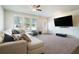 Comfortable living room featuring a plush sectional sofa, bright windows, and modern entertainment setup at 741 Jackson Ct, Social Circle, GA 30025