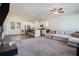 Open-concept living area with a modern kitchen featuring stainless steel appliances and a cozy living room with ample seating at 741 Jackson Ct, Social Circle, GA 30025