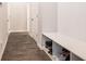 Mudroom boasts wood look floors, shelving, and convenient storage for shoes at 741 Jackson Ct, Social Circle, GA 30025