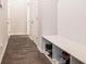 This mudroom features hardwood floors and a white bench with storage for shoes at 741 Jackson Ct, Social Circle, GA 30025