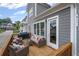 Outdoor deck with a seating arrangement and exterior door entrance at 2003 Haley Walk, Woodstock, GA 30188