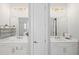 Bright bathroom featuring double sinks, white cabinets, quartz countertop and gold hardware at 2003 Haley Walk, Woodstock, GA 30188