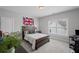 Bedroom featuring a cozy bed, a window for natural light, and unique wall decor at 2003 Haley Walk, Woodstock, GA 30188