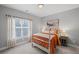 Cozy bedroom with a comfortable bed, bedside tables, artwork and a window with natural light at 2003 Haley Walk, Woodstock, GA 30188